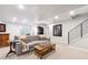Basement living room with gray sofa, wood coffee table, and staircase with black metal railing at 1026 Deer Clover Way, Castle Pines, CO 80108