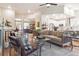 Open concept living room with hardwood floors, ample seating, and seamless access to kitchen at 1026 Deer Clover Way, Castle Pines, CO 80108