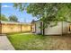 View of backyard, detached garage, manicured lawn and landscaping at 3550 Eudora St, Denver, CO 80207