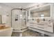 Beautiful bathroom with marble tile, walk-in shower, and double vanity at 3550 Eudora St, Denver, CO 80207