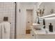 Modern bathroom features a vessel sink, lighted mirror, sleek glass-enclosed shower with black trim and fixtures at 3550 Eudora St, Denver, CO 80207