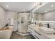 Luxurious bathroom with a sleek glass shower, soaking tub, double vanity, and elegant marble tiling at 3550 Eudora St, Denver, CO 80207