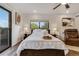 Bright bedroom with hardwood flooring, window and balcony, and styled decor at 3550 Eudora St, Denver, CO 80207