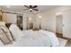 A bright bedroom features a ceiling fan and barn door entrance to the bathroom at 3550 Eudora St, Denver, CO 80207