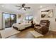 Bright bedroom featuring a cozy chair, balcony and hardwood floors at 3550 Eudora St, Denver, CO 80207