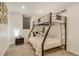 Finished basement bedroom with bunk beds, neutral carpet, and a modern nightstand, with natural light from egress window at 3550 Eudora St, Denver, CO 80207