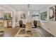 Stylish dining room with contemporary light fixtures, large window and wood floors at 3550 Eudora St, Denver, CO 80207