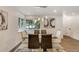 Stylish dining room with contemporary light fixtures, large window and wood floors at 3550 Eudora St, Denver, CO 80207