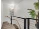 Bright hallway with modern staircase, featuring natural wood steps and a decorative palm tree at 3550 Eudora St, Denver, CO 80207