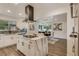 Open concept kitchen with marble countertop island, modern stainless steel appliances, and a view to the dining room at 3550 Eudora St, Denver, CO 80207