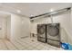 Bright laundry room features a utility sink, tiled floor, and modern washer and dryer at 3550 Eudora St, Denver, CO 80207