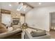 Open living room with high vaulted ceiling, a skylight, a stacked stone fireplace, wood accents and comfortable seating at 3550 Eudora St, Denver, CO 80207