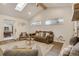Bright living room featuring vaulted ceilings, wood beam, a skylight, natural light, fireplace and modern furnishings at 3550 Eudora St, Denver, CO 80207