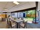 Covered patio with an outdoor dining table, seating, and a view of the backyard at 3550 Eudora St, Denver, CO 80207