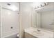 Clean bathroom with single sink vanity and bathtub shower at 1433 N Williams St # 801, Denver, CO 80218