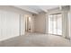 Bright bedroom with mirrored closet doors and access to balcony at 1433 N Williams St # 801, Denver, CO 80218