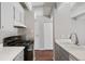 Clean kitchen, featuring gray cabinets and a stove at 1433 N Williams St # 801, Denver, CO 80218