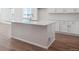 Modern kitchen island with white cabinets and quartz countertops at 24510 E 36Th Ave, Aurora, CO 80019