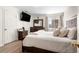 Comfortable bedroom with a plush bed, wood floors, and dark wood furniture at 724 Ursula St, Aurora, CO 80011