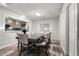 Elegant dining room with hardwood floors, seamlessly connected to the modern kitchen with stylish finishes at 724 Ursula St, Aurora, CO 80011