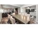 Open-concept layout featuring a dining room with a large table and chairs, flowing into the living room and kitchen at 724 Ursula St, Aurora, CO 80011