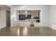 Modern kitchen with stainless steel appliances, stylish backsplash, and ample counter space, viewed from the dining area at 724 Ursula St, Aurora, CO 80011