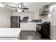 Bright kitchen featuring stainless steel appliances, white cabinets, and a stylish backsplash at 724 Ursula St, Aurora, CO 80011
