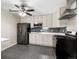 Bright kitchen featuring stainless steel appliances, white cabinets, and a stylish backsplash at 724 Ursula St, Aurora, CO 80011