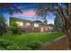 Large backyard with mature trees and a covered patio area for entertaining at 3970 S Syracuse Way, Denver, CO 80237