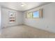 Bright bedroom with large windows and neutral carpet at 3970 S Syracuse Way, Denver, CO 80237