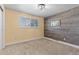 Cozy bedroom with wood accent wall, carpet, and ample natural light at 3970 S Syracuse Way, Denver, CO 80237