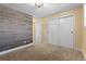 Bedroom features modern accent wall, neutral carpet, and spacious closet space at 3970 S Syracuse Way, Denver, CO 80237