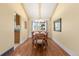 Bright dining room with hardwood floors and a window overlooking the yard at 3970 S Syracuse Way, Denver, CO 80237