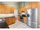 Modern kitchen with stainless steel appliances and wood cabinetry at 3970 S Syracuse Way, Denver, CO 80237
