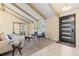 Inviting living room with exposed beams, large window, and seating area at 3970 S Syracuse Way, Denver, CO 80237