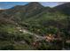 Scenic aerial view of a mountain neighborhood with lush greenery and charming homes at 2874 Se Grapevine Rd, Idledale, CO 80453
