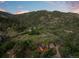 Mountain homes nestled amongst pines on a hillside with beautiful sunset sky at 2874 Se Grapevine Rd, Idledale, CO 80453
