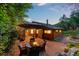 Cozy back patio area with stone pavers, seating, and large umbrella at 2874 Se Grapevine Rd, Idledale, CO 80453