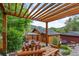 Outdoor space with a pergola, lush greenery and mountain views at 2874 Se Grapevine Rd, Idledale, CO 80453