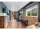 Finished basement with exposed brick, exercise bike, media and access to backyard patio at 2874 Se Grapevine Rd, Idledale, CO 80453