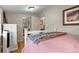Cozy bedroom displays hardwood floors, soft pink bedding, and a mirror closet door at 2874 Se Grapevine Rd, Idledale, CO 80453
