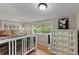 Comfortable bedroom features hardwood floors, neutral walls, and a large window with mountain views at 2874 Se Grapevine Rd, Idledale, CO 80453