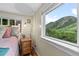 Bright bedroom with hardwood floors and a large window with views of the landscape at 2874 Se Grapevine Rd, Idledale, CO 80453