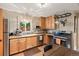 Bright kitchen features stainless steel appliances, wood cabinets, and a window overlooking the backyard at 2874 Se Grapevine Rd, Idledale, CO 80453
