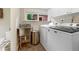 Functional laundry room featuring updated appliances, a utility sink, and ample storage space at 2874 Se Grapevine Rd, Idledale, CO 80453