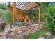 Wooden pergola with outdoor seating on stone patio at 2874 Se Grapevine Rd, Idledale, CO 80453