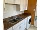 Functional kitchen featuring a stainless steel sink, white cabinets, and bright countertops at 3531 Forest St, Denver, CO 80207