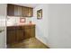 Small basement bar area with dark wooden cabinets and a sink with orange countertop at 4641 W Ponds Cir, Littleton, CO 80123