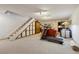 Basement area with a carpeted staircase, neutral walls and carpet, and a workout area at 4641 W Ponds Cir, Littleton, CO 80123