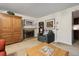 Sitting area in basement with fireplace, dark gray easy chair, and neutral carpet at 4641 W Ponds Cir, Littleton, CO 80123